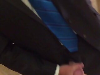 Suited guy cums in a bathroom and leaves his mark.